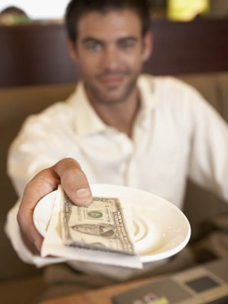 Man Paying in Restaurant --- Image by © C. Devan/Corbis