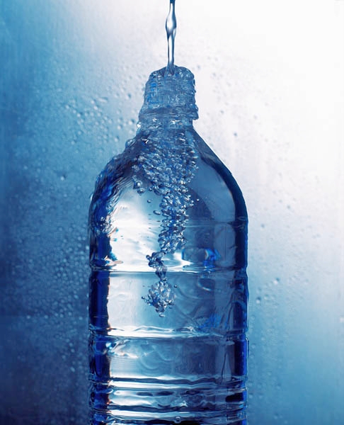 Water Pouring into Bottle